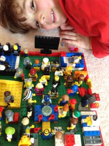 Child with Lego Mini Figures.